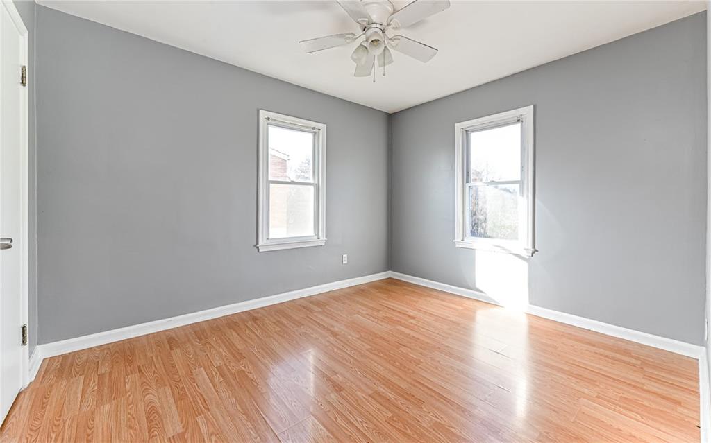 1711 Mercer Street Aliquippa, PA 15001 - Photo 13 of 27 a view of an empty room with wooden floor and a window