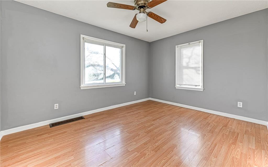 1711 Mercer Street Aliquippa, PA 15001 - Photo 14 of 27 a view of an empty room with wooden floor and a window
