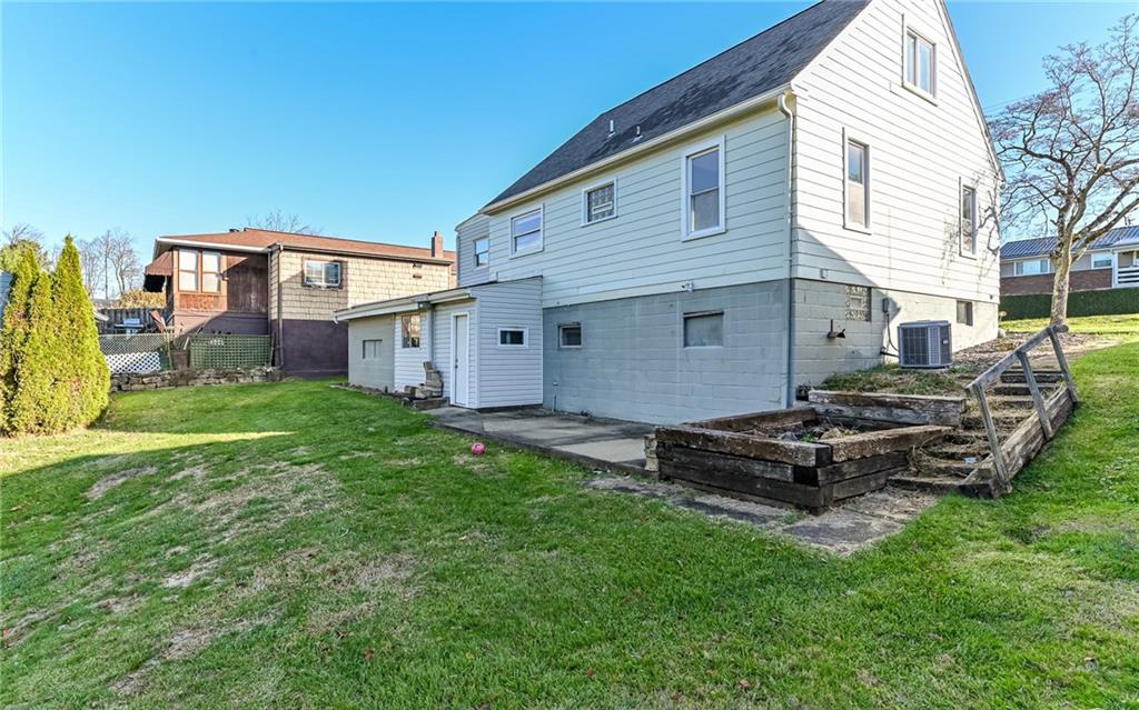 1711 Mercer Street Aliquippa, PA 15001 - Photo 25 of 27 a view of a backyard with plants and a large tree
