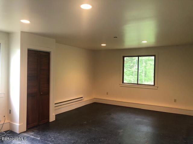 14 Sandisfield Road Sandisfield, MA 01255 - Photo 8 of 26 an empty room with wooden floor and windows