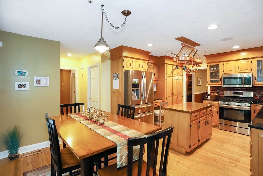29 Lexington Drive, Unit 29 Atkinson, NH 03811 - Photo 11 of 31 a kitchen with stainless steel appliances granite countertop a sink a stove and chairs