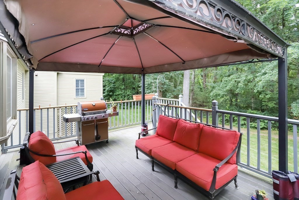 29 Lexington Drive, Unit 29 Atkinson, NH 03811 - Photo 14 of 31 a balcony with furniture and umbrella