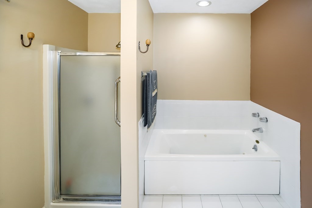 29 Lexington Drive, Unit 29 Atkinson, NH 03811 - Photo 18 of 31 a bathroom with a bathtub and a shower