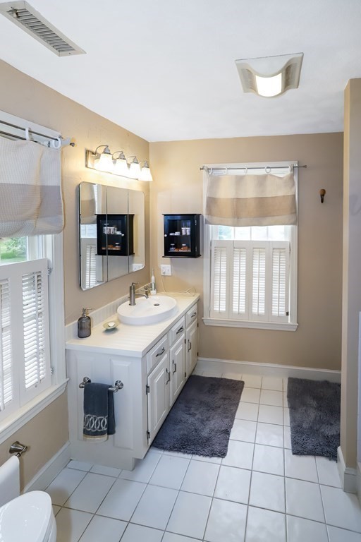 29 Lexington Drive, Unit 29 Atkinson, NH 03811 - Photo 19 of 31 a spacious bathroom with a sink a mirror and a bathtub