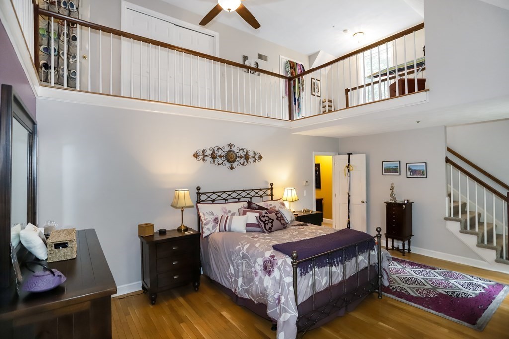 29 Lexington Drive, Unit 29 Atkinson, NH 03811 - Photo 20 of 31 a bedroom with a bed and wooden floor