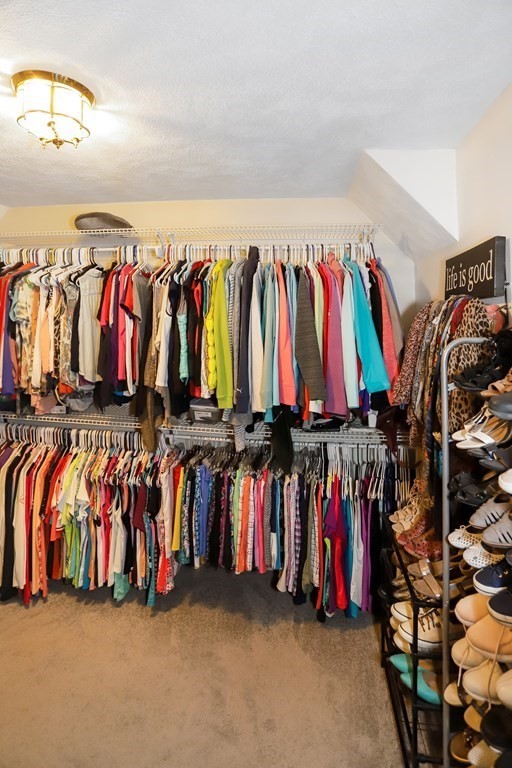 29 Lexington Drive, Unit 29 Atkinson, NH 03811 - Photo 22 of 31 a view of walk in closet with clothes and shoes