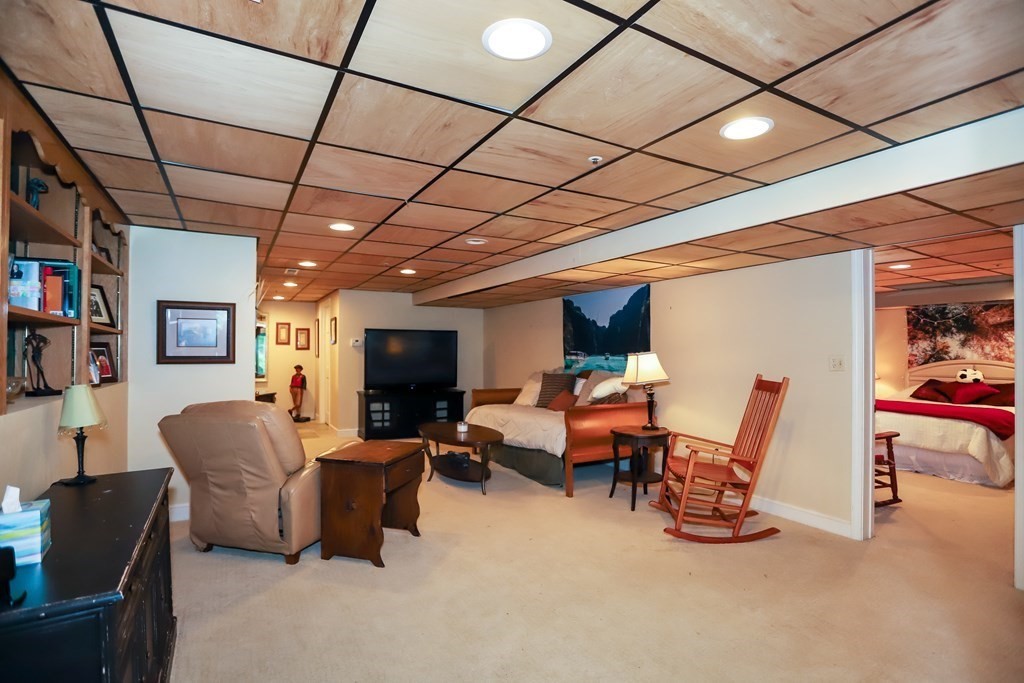29 Lexington Drive, Unit 29 Atkinson, NH 03811 - Photo 25 of 31 a living room with furniture and a flat screen tv