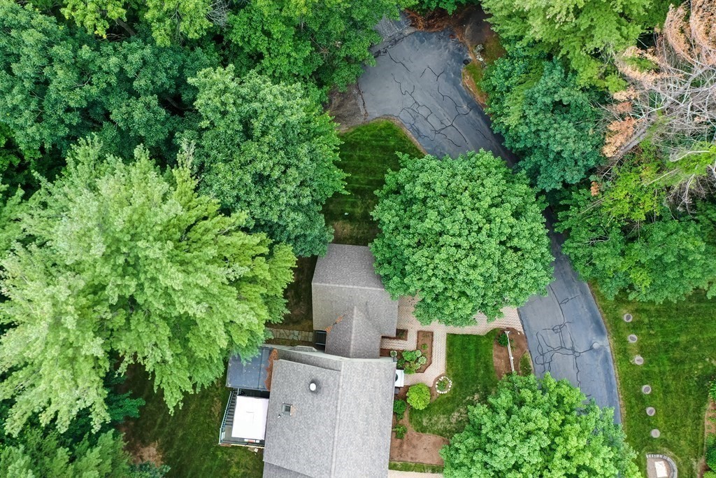 29 Lexington Drive, Unit 29 Atkinson, NH 03811 - Photo 5 of 31 an aerial view of a house with a yard and large trees