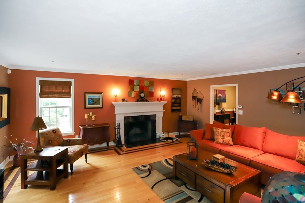 29 Lexington Drive, Unit 29 Atkinson, NH 03811 - Photo 7 of 31 a living room with furniture a fireplace and a flat screen tv