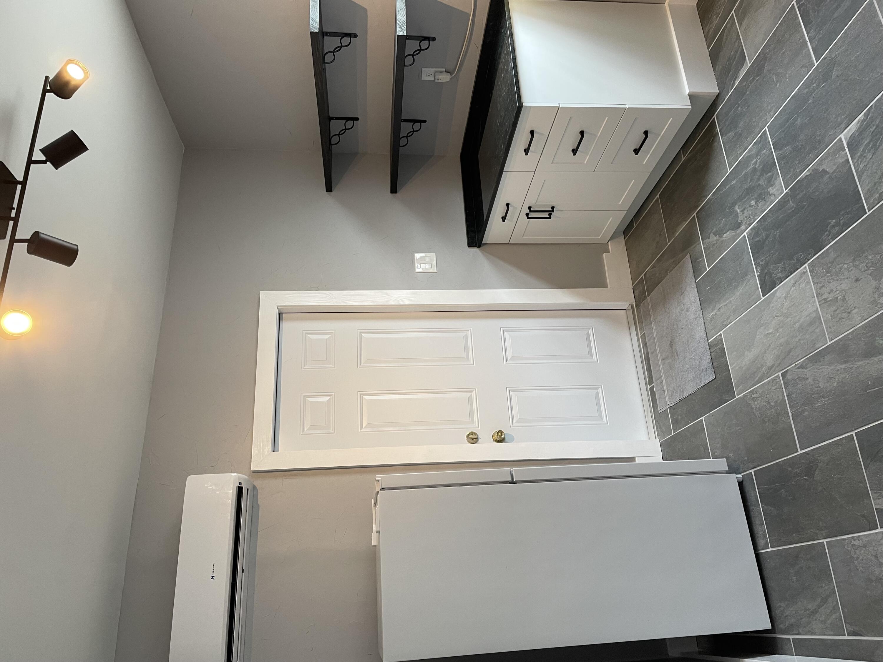432 15th Street, Unit 2 West Palm Beach, FL 33401 - Photo 1 of 10 a kitchen with a refrigerator and white cabinets
