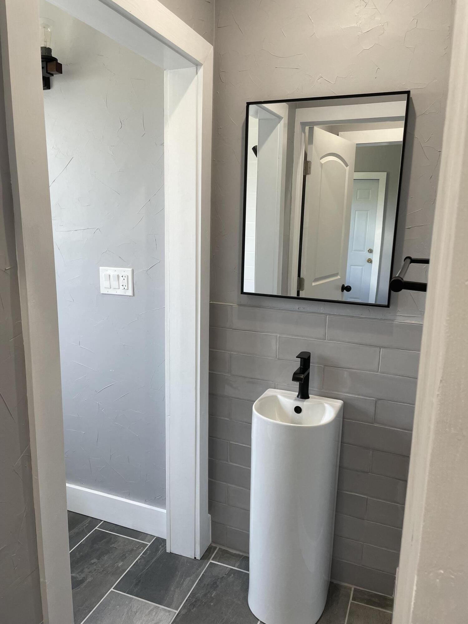 432 15th Street, Unit 2 West Palm Beach, FL 33401 - Photo 5 of 10 a bathroom with a sink and mirror