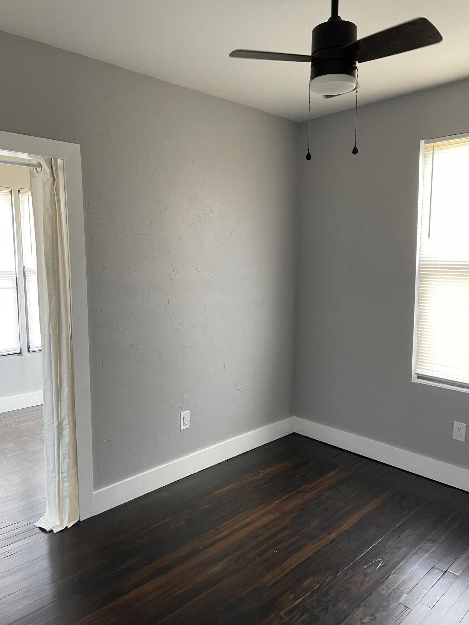 432 15th Street, Unit 2 West Palm Beach, FL 33401 - Photo 7 of 10 a view of an empty room with wooden floor and a window