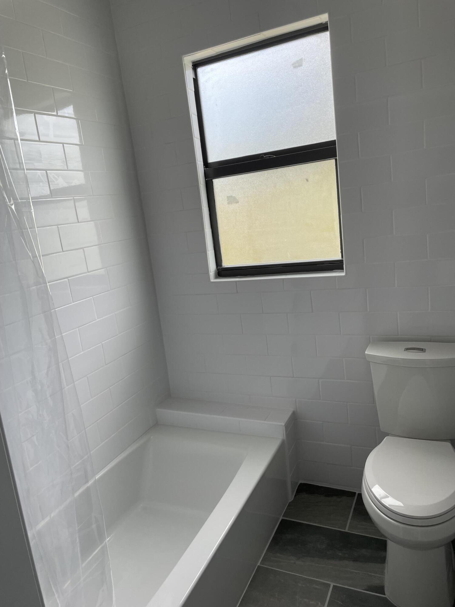 432 15th Street, Unit 2 West Palm Beach, FL 33401 - Photo 8 of 10 a bathroom with a toilet and a bathtub