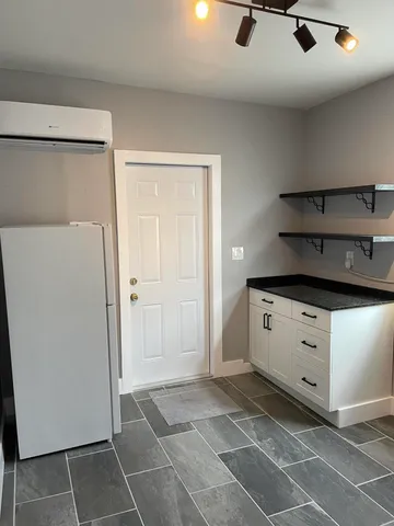 a kitchen with granite countertop a sink cabinets and stainless steel appliances