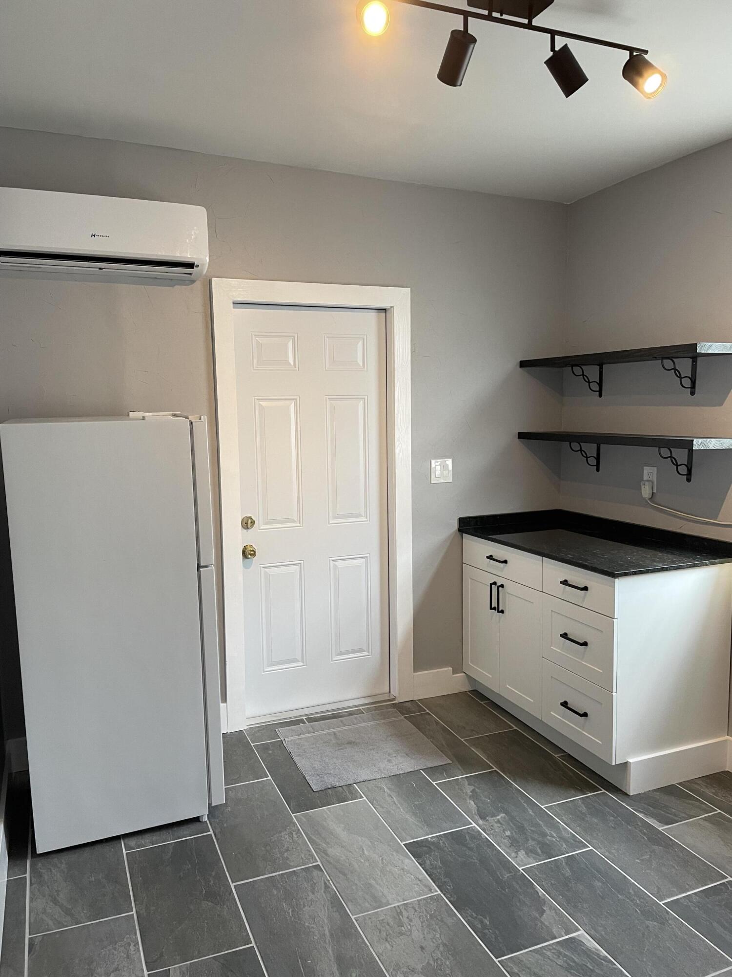 432 15th Street, Unit 2 West Palm Beach, FL 33401 - Photo 9 of 10 a kitchen with a refrigerator and white cabinets