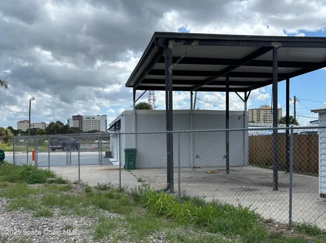 a roof deck with table and chairs under an umbrella