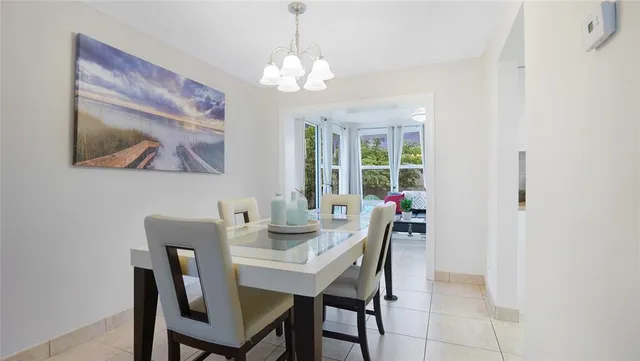 a view of a dining room with furniture and chandelier