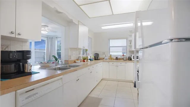 a kitchen with a sink cabinets and window