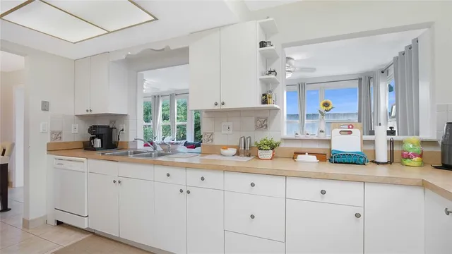 a kitchen with white cabinets and a sink