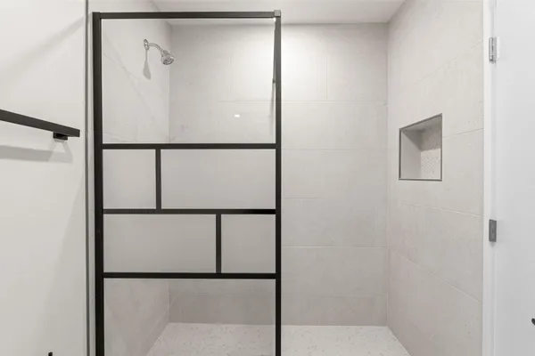 a bathroom with a glass shower door