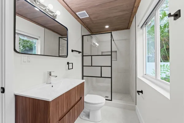 a bathroom with a sink toilet and shower