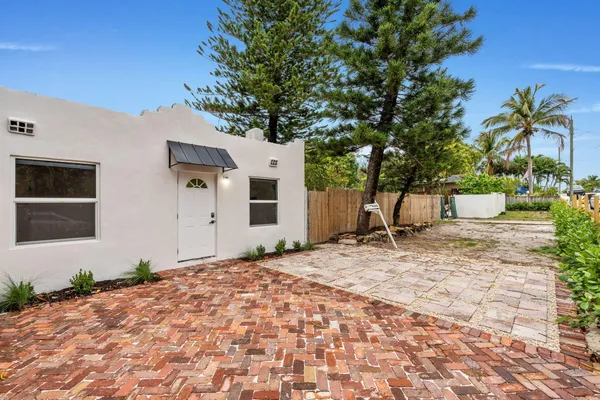 a row of white house with tree in front of it