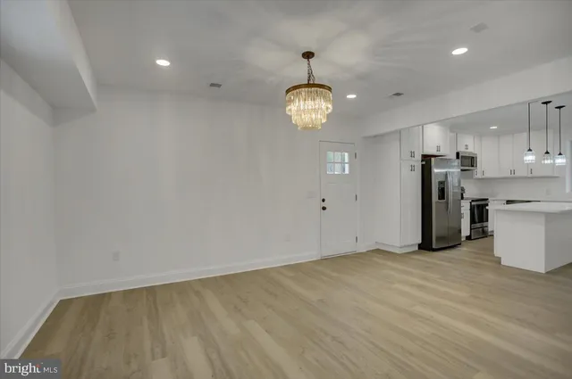 a view of a kitchen with a sink and stainless steel appliances