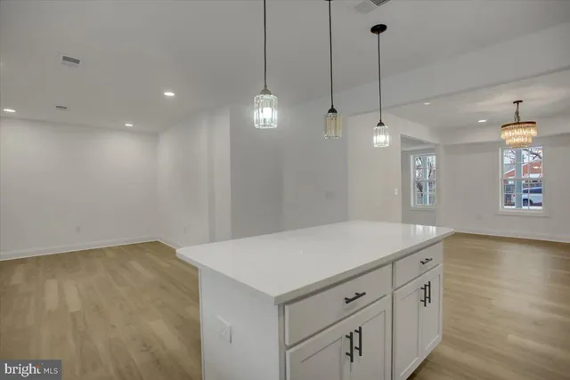 a view of a kitchen with marble top and a sink