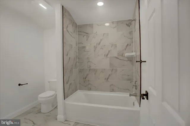 a bathroom with a bathtub and a toilet