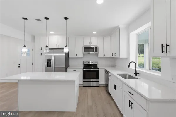 a kitchen with sink cabinets and microwave