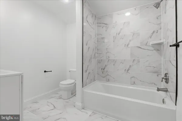a bathroom with a bathtub and a sink