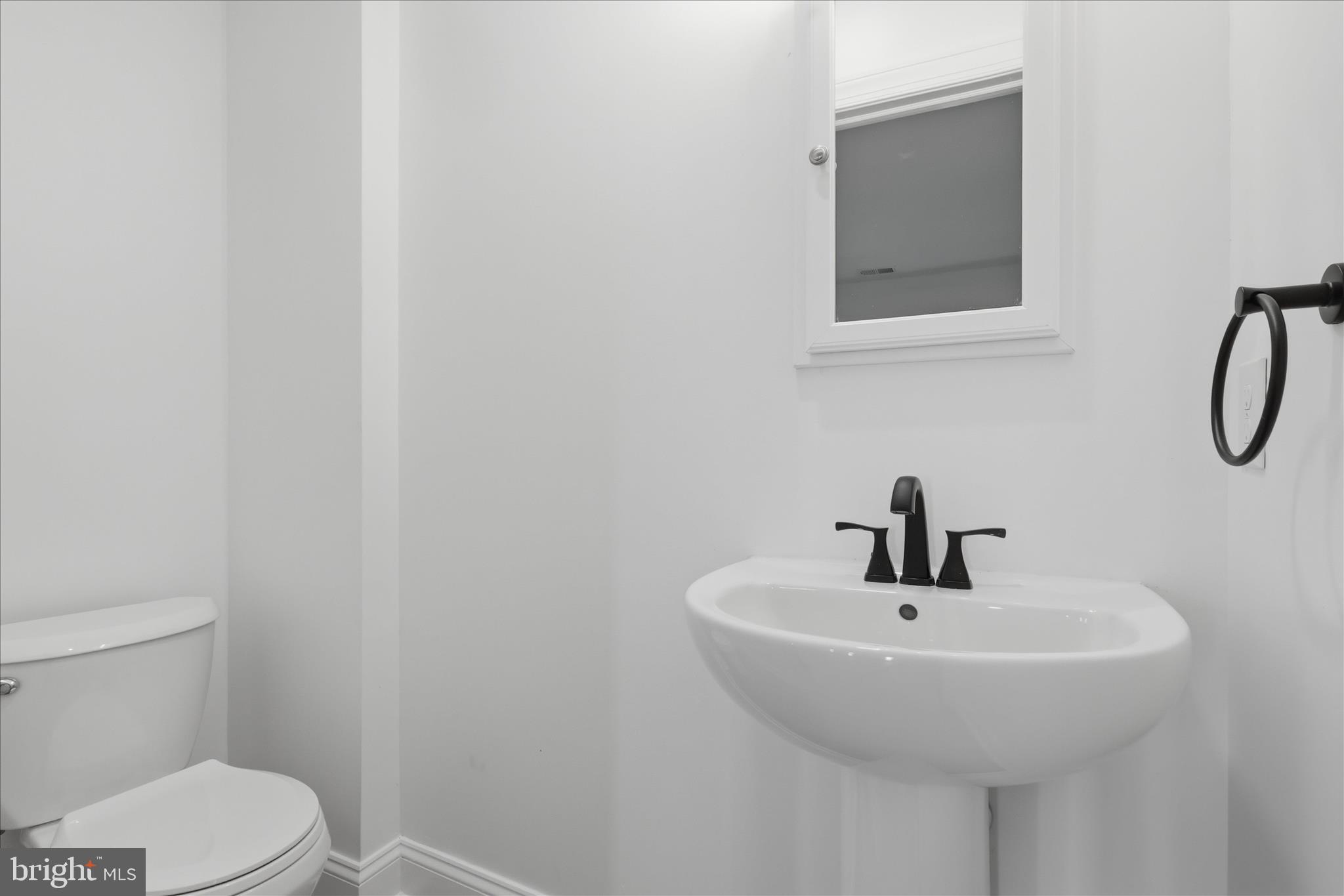 50 St Paul Street Boonsboro, MD 21713 - Photo 34 of 81 a bathroom with a sink a toilet and a mirror