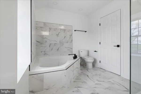 a bathroom with a granite countertop sink mirror and shower