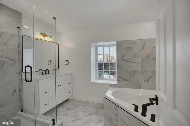 a white bath tub sitting in a bathroom
