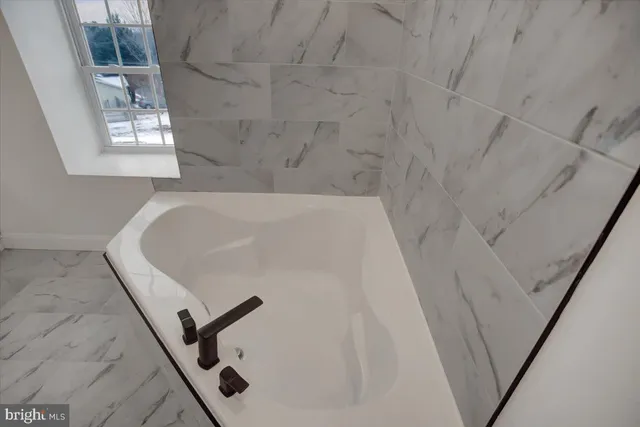 a bathroom with a double vanity sink a mirror and shower