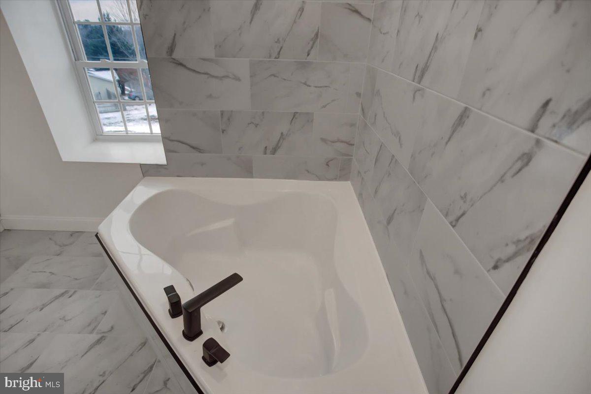 50 St Paul Street Boonsboro, MD 21713 - Photo 36 of 39 a white bath tub sitting in a bathroom