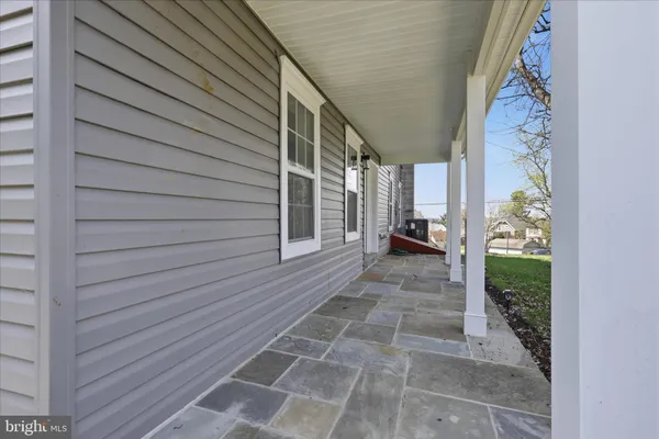 a view of a pathway of a house with wooden walls