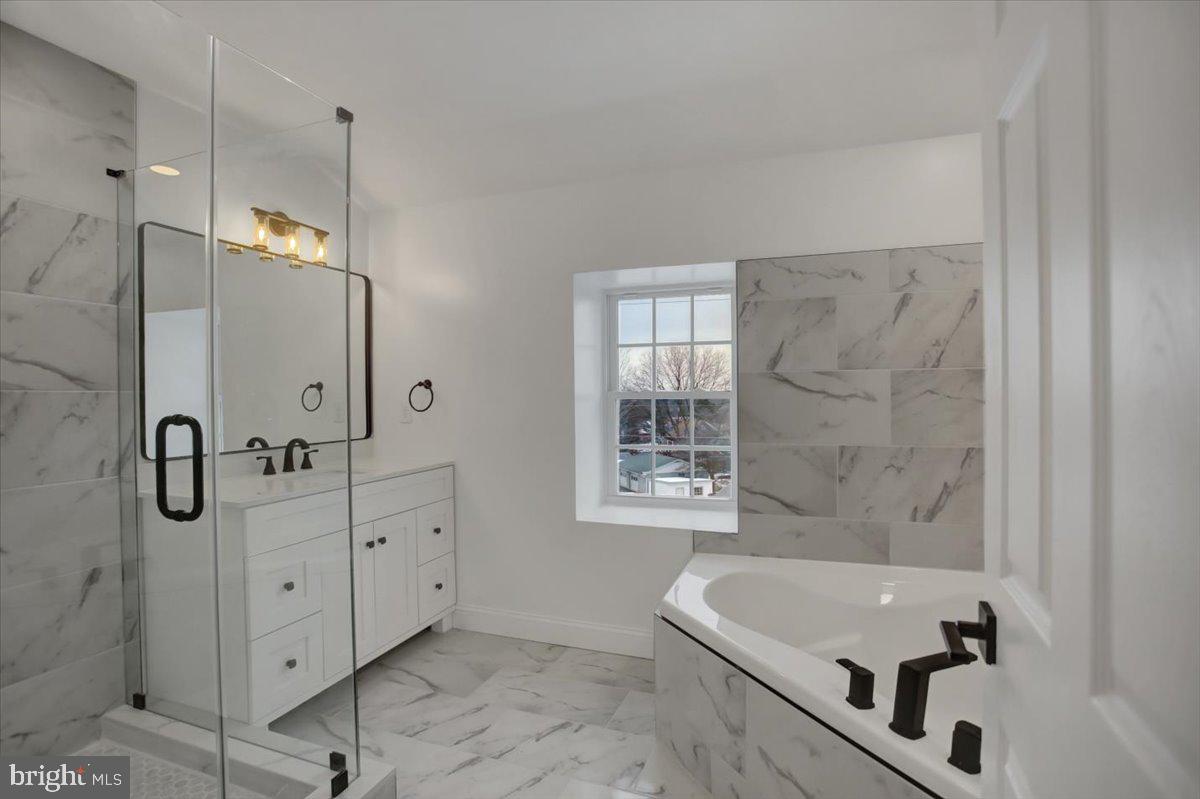 50 St Paul Street Boonsboro, MD 21713 - Photo 69 of 81 a bathroom with a tub sink and mirror