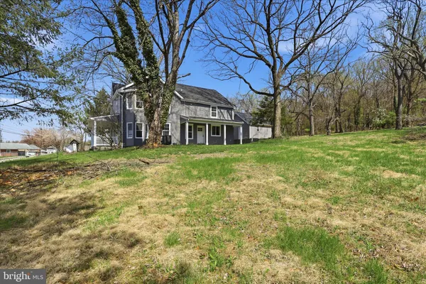 a brick house with trees in front of it