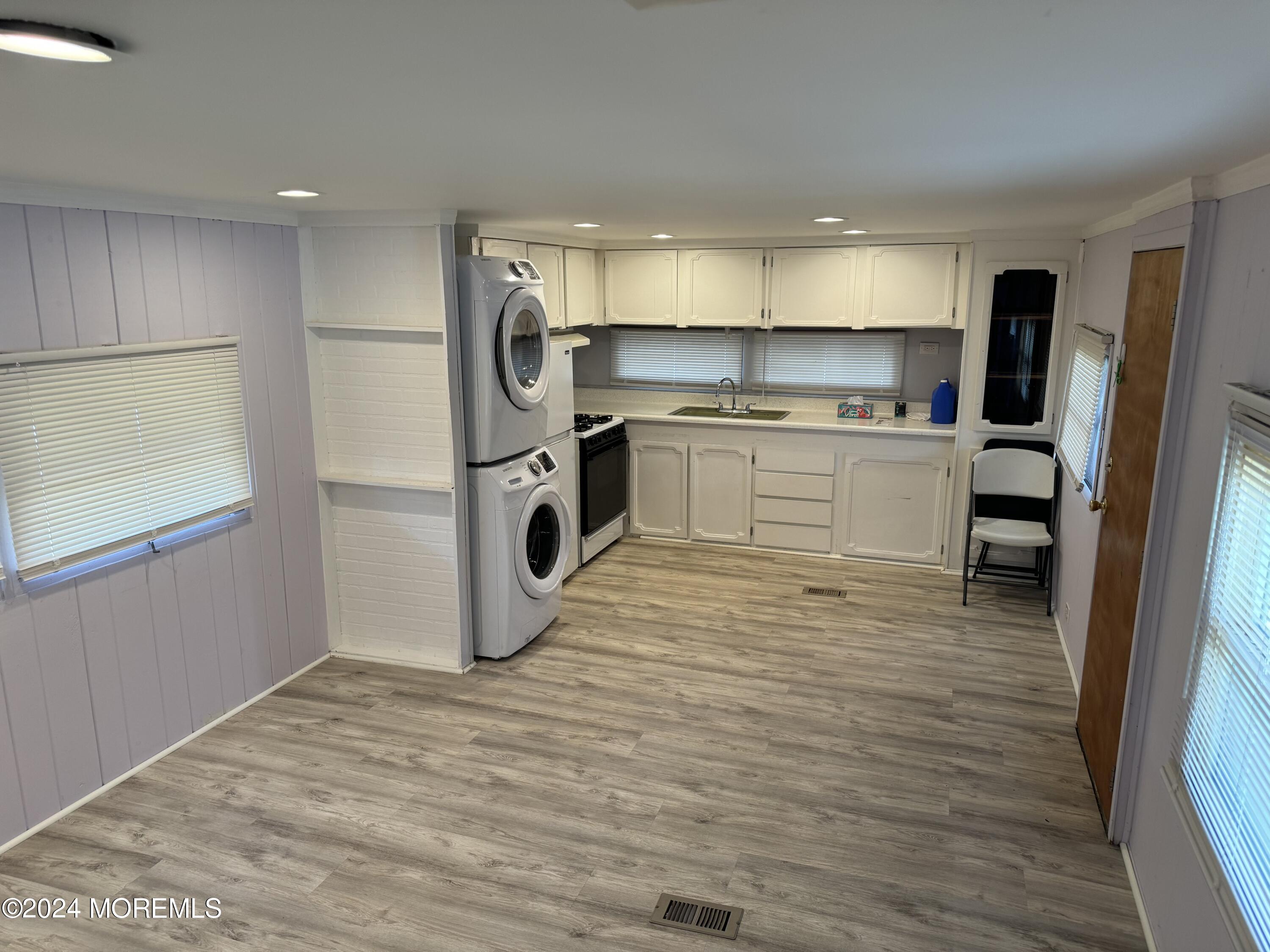 a kitchen with a refrigerator and a stove top oven