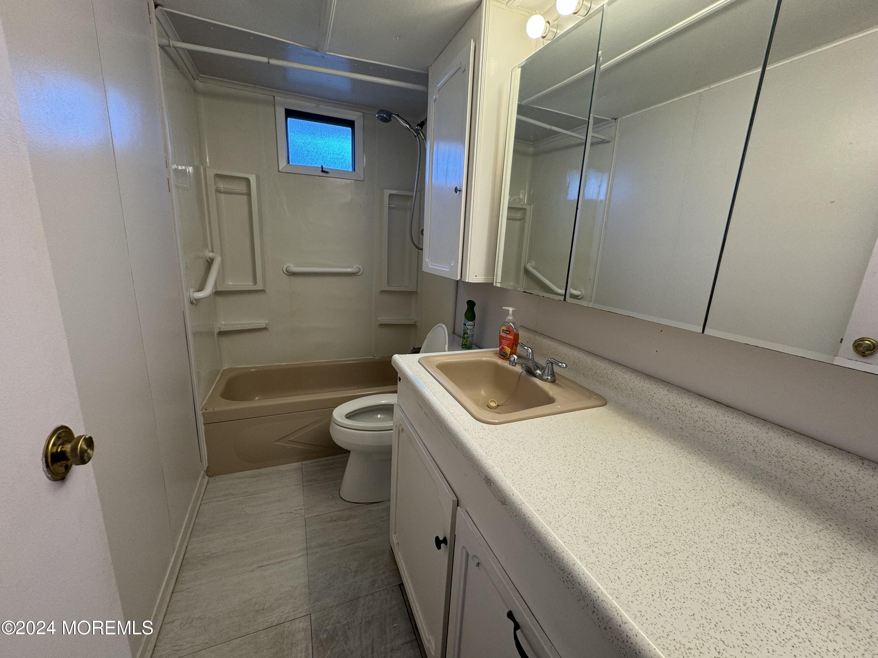 127 Lane B Hazlet, NJ 07730 - Photo 5 of 6 a bathroom with a sink a toilet and shower