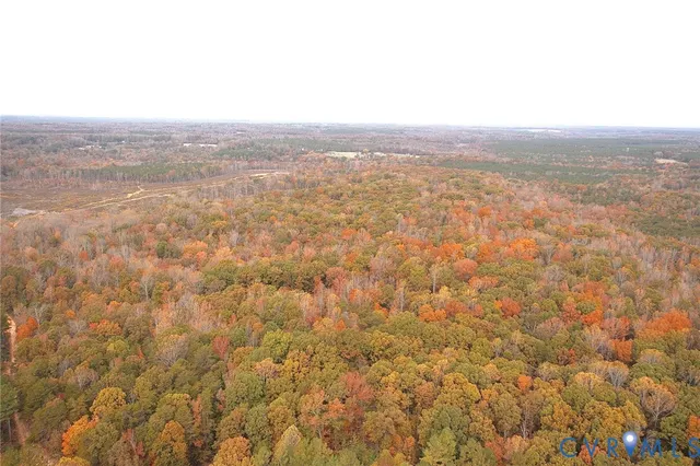 an aerial view of residential space with green field