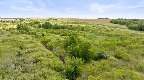 a view of a field with an ocean