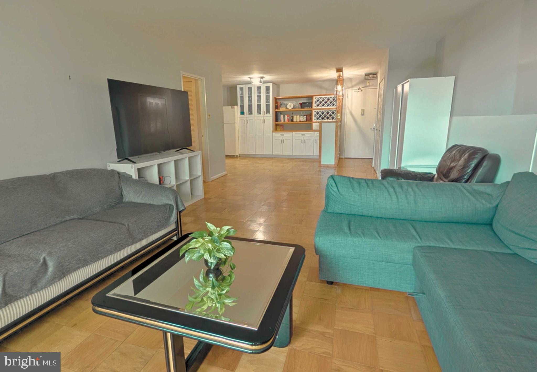 5101 River Road, Unit 405 Bethesda, MD 20816 - Photo 6 of 20 a living room with furniture and a flat screen tv