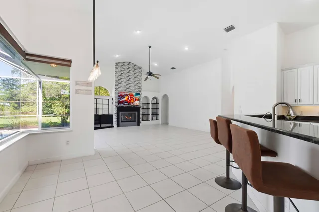 a kitchen with granite countertop white cabinets and stainless steel appliances