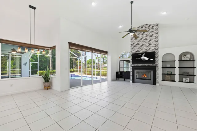 a kitchen with kitchen island cabinets a sink a counter and a refrigerator
