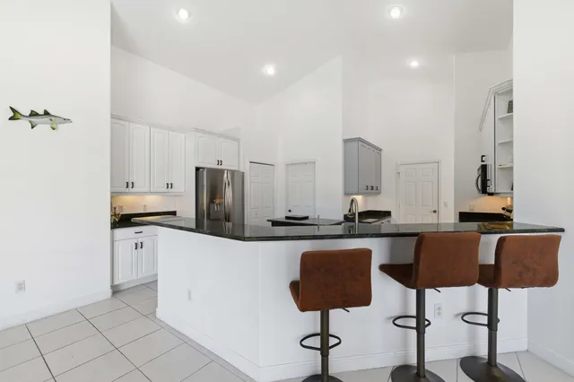 a view of empty room with wooden floor and ceiling fan