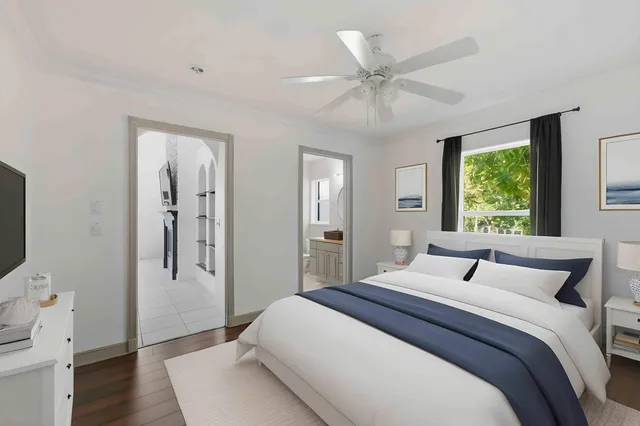 a bedroom with a bed and a chandelier