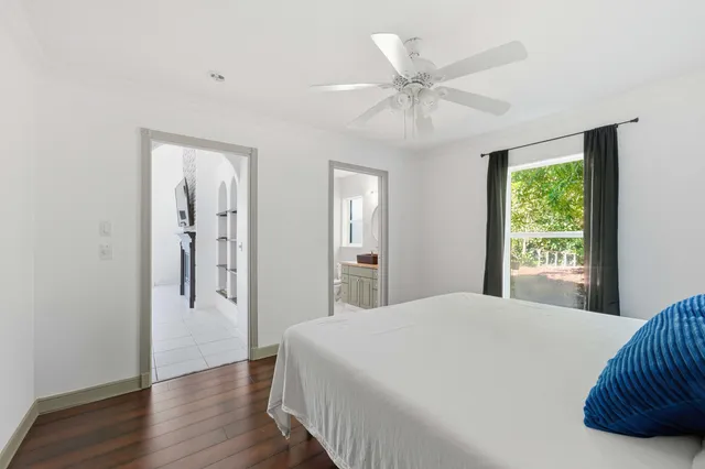 a view of empty room with wooden floor and window