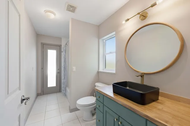 a front view of a house with swing and table